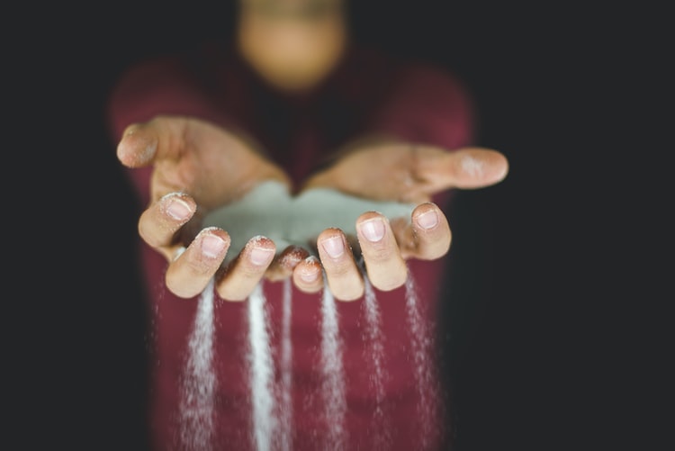 Sand running through hands